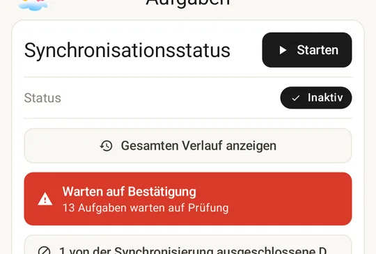 Sync Status card with the awaiting-confirmation alert: tasks have been parked for review instead of running automatically.